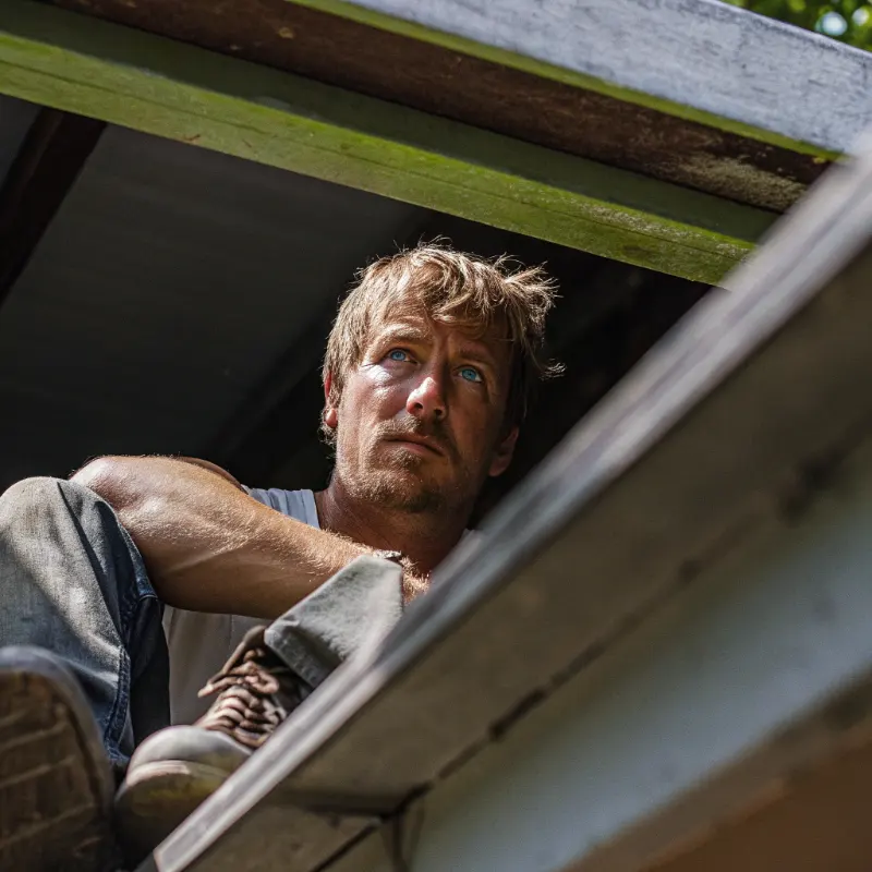 Tim Kelly inspecting hemp plants at No Boundaries Farm
